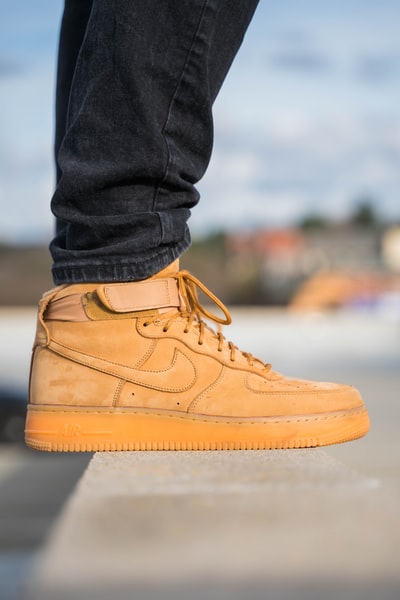 A brown pair of Nike Air Force 1 high shoes
